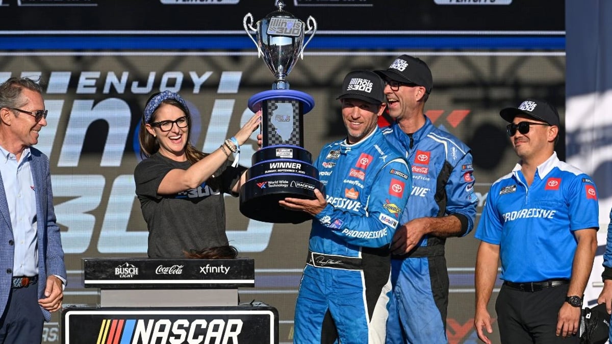 NASCAR Cup Series driver Denny Hamlin (11) hosts the trophy after winning the Enjoy Illinois 300 at World Wide Technology Raceway.