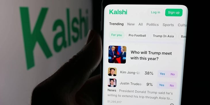 A phone screen displays the Kalshi prediction market app in front of the company's logo